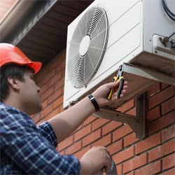 man-fixing-the-AC unit